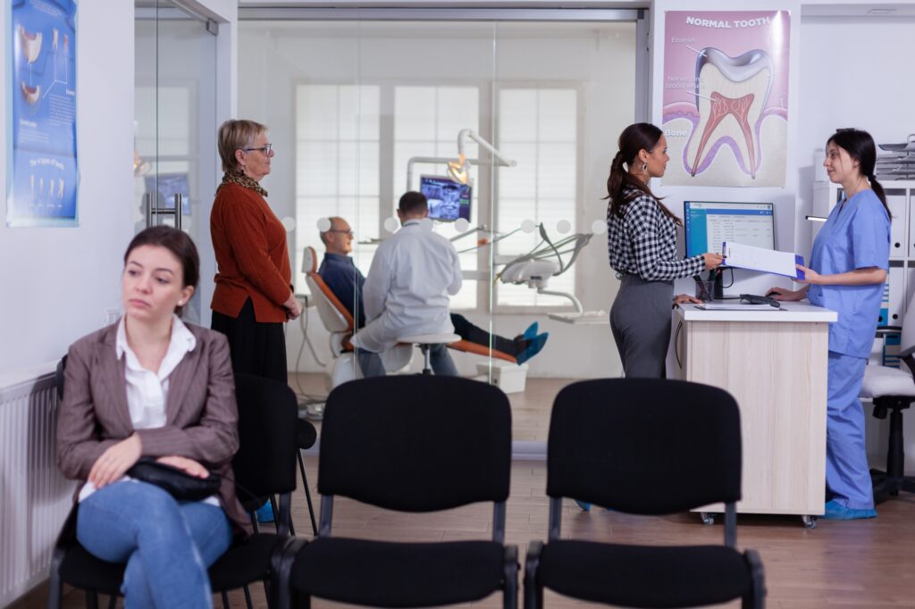 patientsstomatology reception waiting line taking filling form doctor examining senior man discussing teeh healthcare